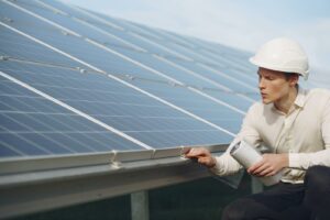 Solar Technician Inspecting Solar Panels