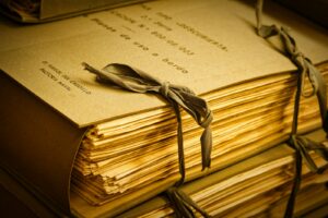 A stack of books with a bow on top of it